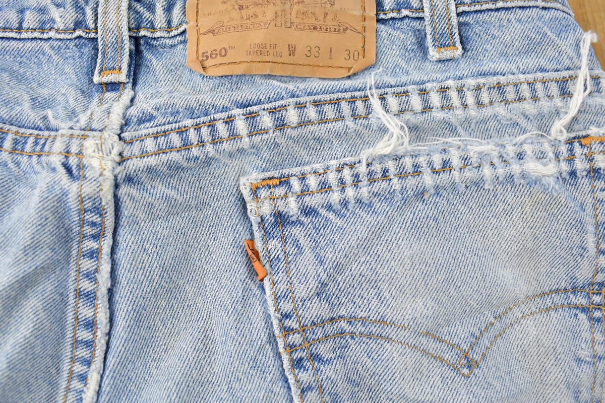 Vintage 1990s Distressed Levi's 560 Loose Fit Denim Blue Jeans Men's 32 x 26.5