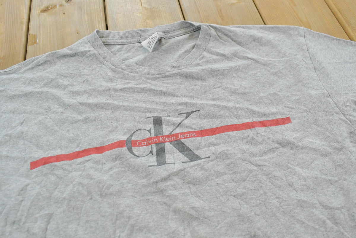 Vintage 1990s Calvin Klein Jeans Logo Graphic T-Shirt Men's XL
