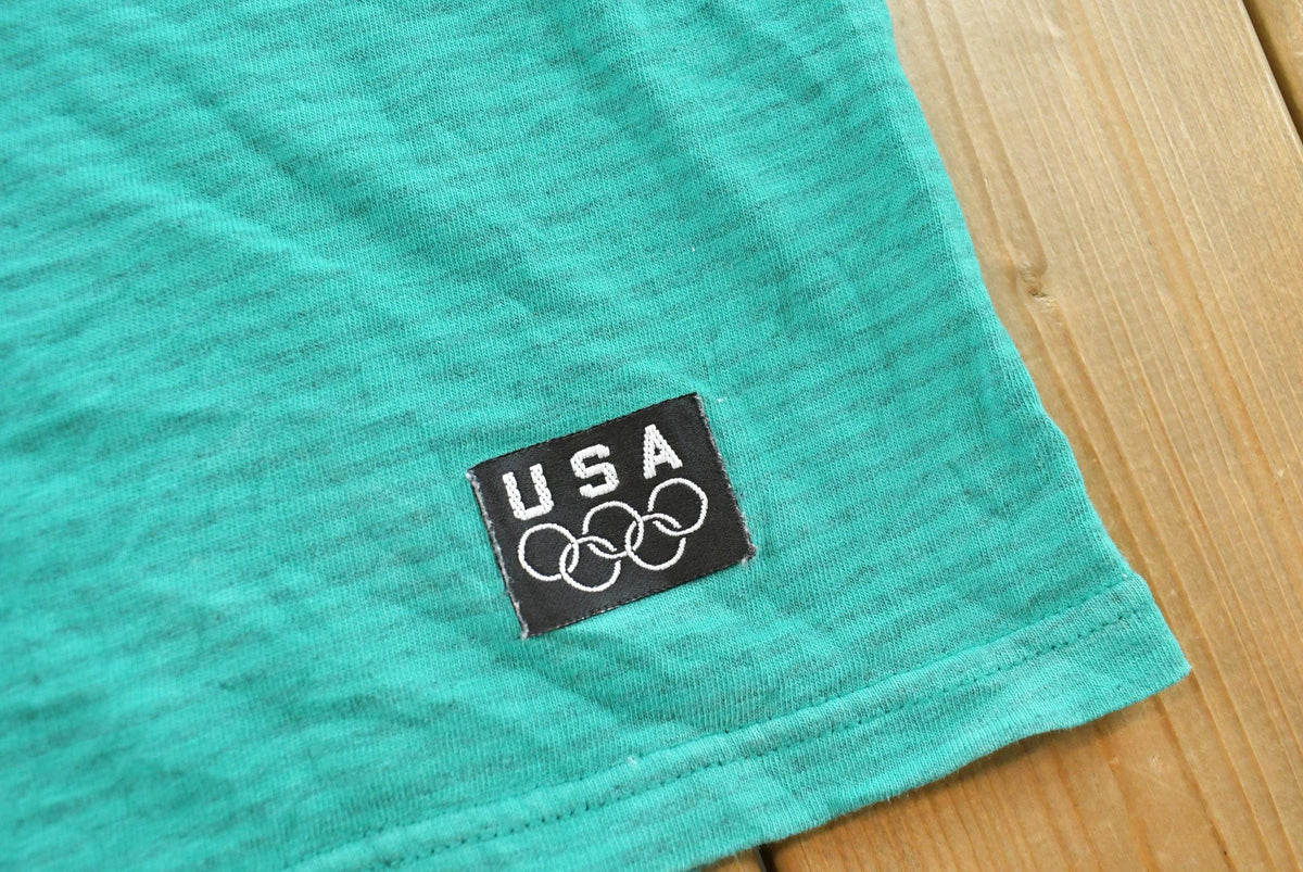 Vintage 1990s USA Olympic Rings JC Penney Micro Stripe Teal T-Shirt Men's L