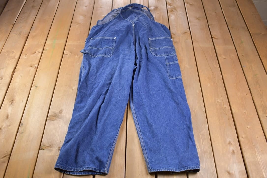 Carhartt Clothing > Gender Neutral Adult Clothing > Overalls & Coveralls Vintage 1990s Carhartt Blue Denim Overalls Men's 50 x 28