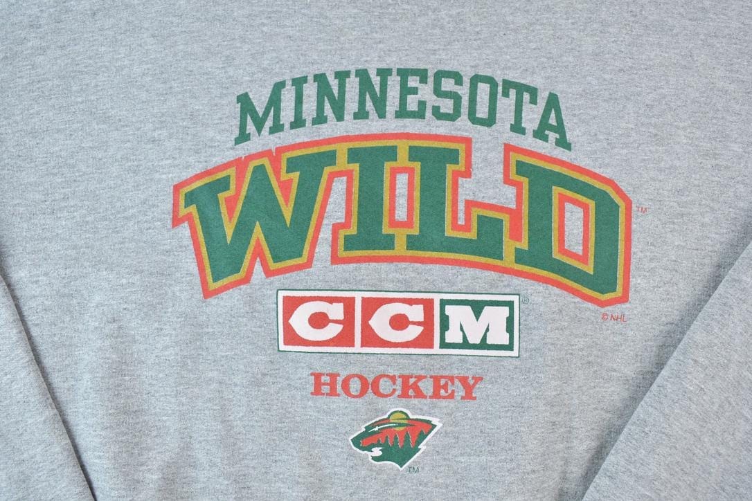 CCM Clothing > Gender Neutral Adult Clothing > Hoodies & Sweatshirts > Sweatshirts Vintage 1990s Minnesota Wild NHL CCM Hockey Crewneck Sweatshirt Men's 2XL