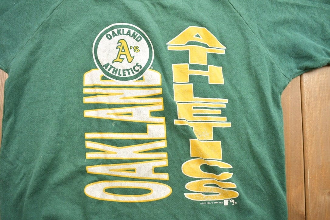 MLB Clothing > Gender Neutral Adult Clothing > Tops & Tees > T Shirts Vintage 1989 Oakland Athletics MLB Graphic Raglan T-Shirt Men's XL