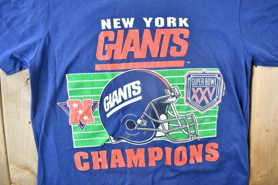 NFL Clothing > Gender Neutral Adult Clothing > Tops & Tees > T Shirts Vintage 1989 New York Giants NFL Super Bowl Champions T-shirt Men's Large