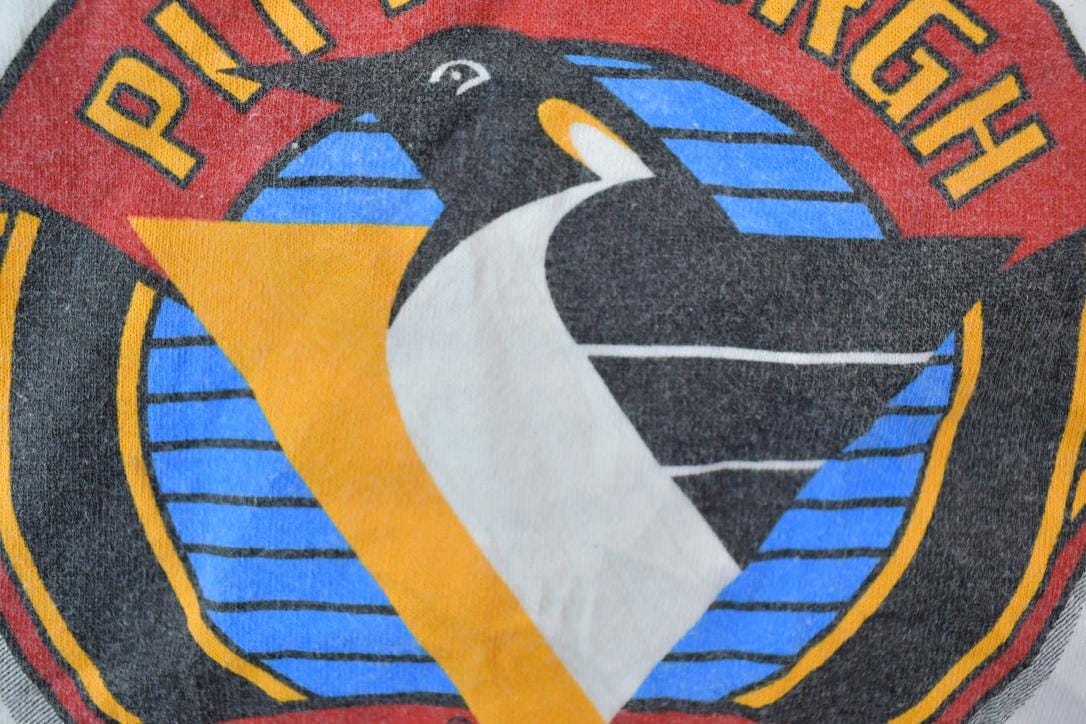 NHL Clothing > Gender Neutral Adult Clothing > Tops & Tees > T Shirts Vintage 1990s Pittsburgh Penguins Lets Go Pens NHL Graphic T-Shirt Men's 3XL