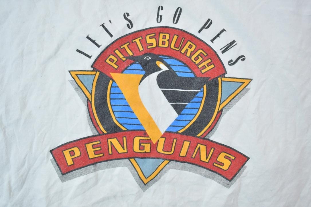 NHL Clothing > Gender Neutral Adult Clothing > Tops & Tees > T Shirts Vintage 1990s Pittsburgh Penguins Lets Go Pens NHL Graphic T-Shirt Men's 3XL