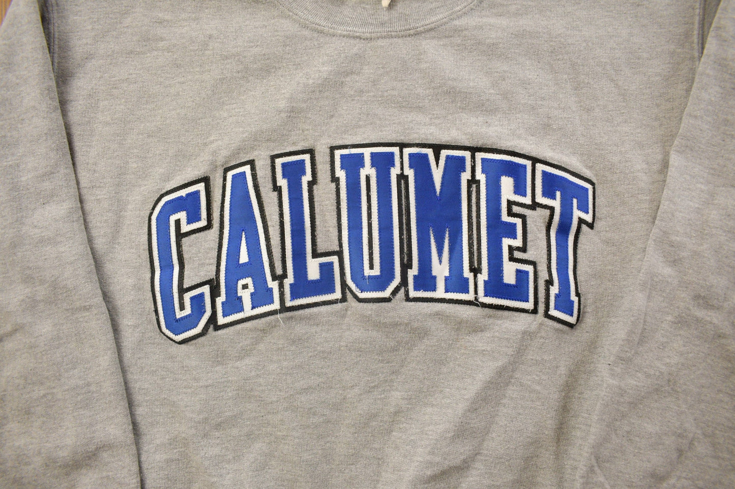 Proper Vintage Clothing > Gender Neutral Adult Clothing > Hoodies & Sweatshirts > Sweatshirts Vintage 1990s Calumet College Crewneck / Embroidered / NCAA Sweatshirt / Sportswear / Americana