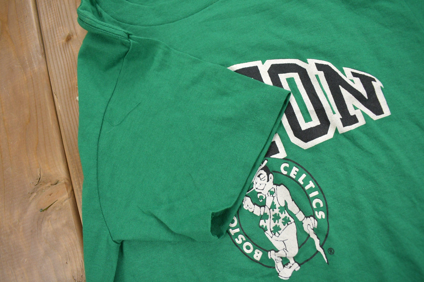 Proper Vintage Clothing > Gender Neutral Adult Clothing > Tops & Tees > T Shirts Vintage 1980s Deadstock Boston Celtics NBA Champion T-Shirt / Made In USA / Single Stitch / NBA Basketball / New With Tags / Sportswear