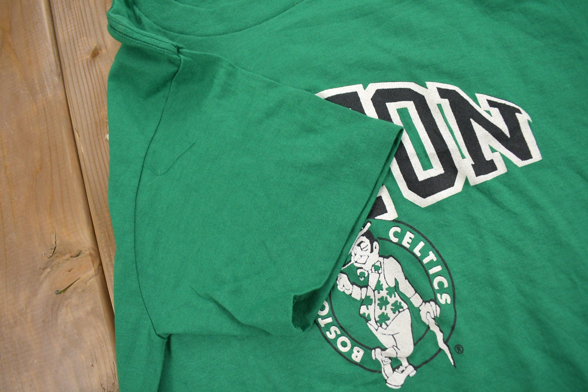 Proper Vintage Clothing > Gender Neutral Adult Clothing > Tops & Tees > T Shirts Vintage 1980s Deadstock Boston Celtics NBA Champion T-Shirt / Made In USA / Single Stitch / NBA Basketball / New With Tags / Sportswear
