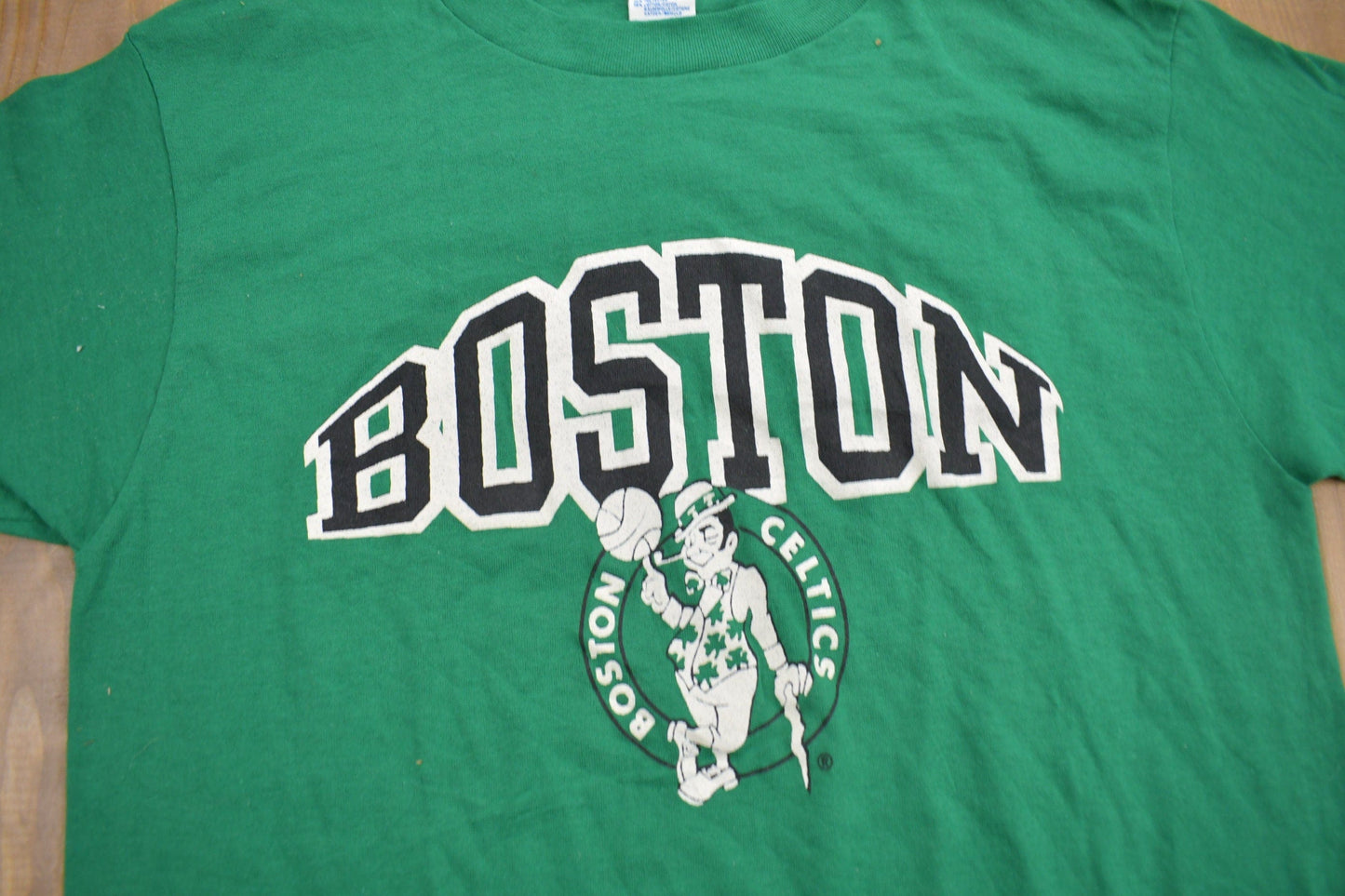 Proper Vintage Clothing > Gender Neutral Adult Clothing > Tops & Tees > T Shirts Vintage 1980s Deadstock Boston Celtics NBA Champion T-Shirt / Made In USA / Single Stitch / NBA Basketball / New With Tags / Sportswear
