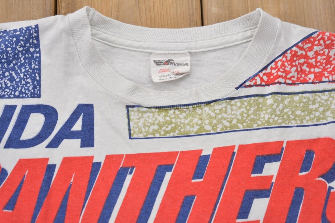 Proper Vintage Clothing > Gender Neutral Adult Clothing > Tops & Tees > T Shirts Vintage 1990s Florida Panthers All Over Print NHL Graphic Kids T-Shirt Made In Canada / Single Stitch / NHL Hockey / 90s Salem