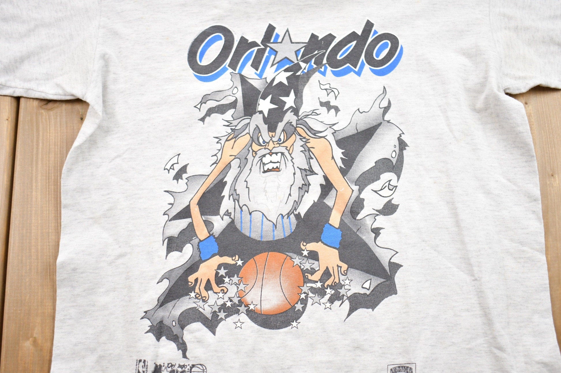 Proper Vintage Clothing > Gender Neutral Adult Clothing > Tops & Tees > T Shirts Vintage 1990s Orlando Magic Graphic T-Shirt / 90s Nutmeg T-Shirt / Streetwear / Retro Style / Single Stitch / Made In USA / NBA Graphic Tee
