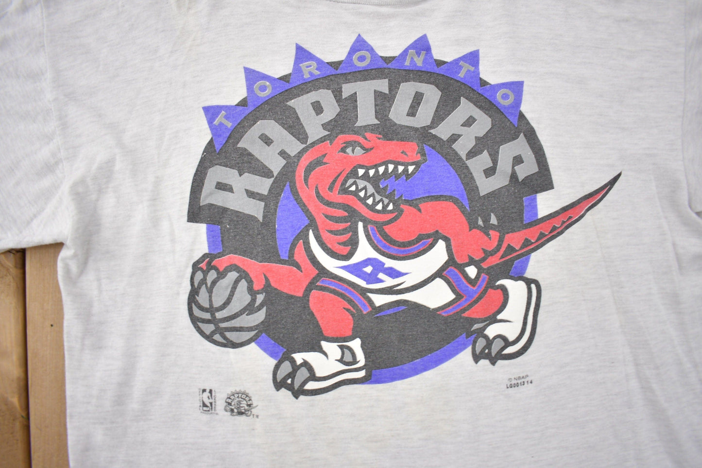 Proper Vintage Clothing > Gender Neutral Adult Clothing > Tops & Tees > T Shirts Vintage 1990s Toronto Raptors NBA Graphic T-Shirt / Made In USA / Sportswear / Vintage NBA
