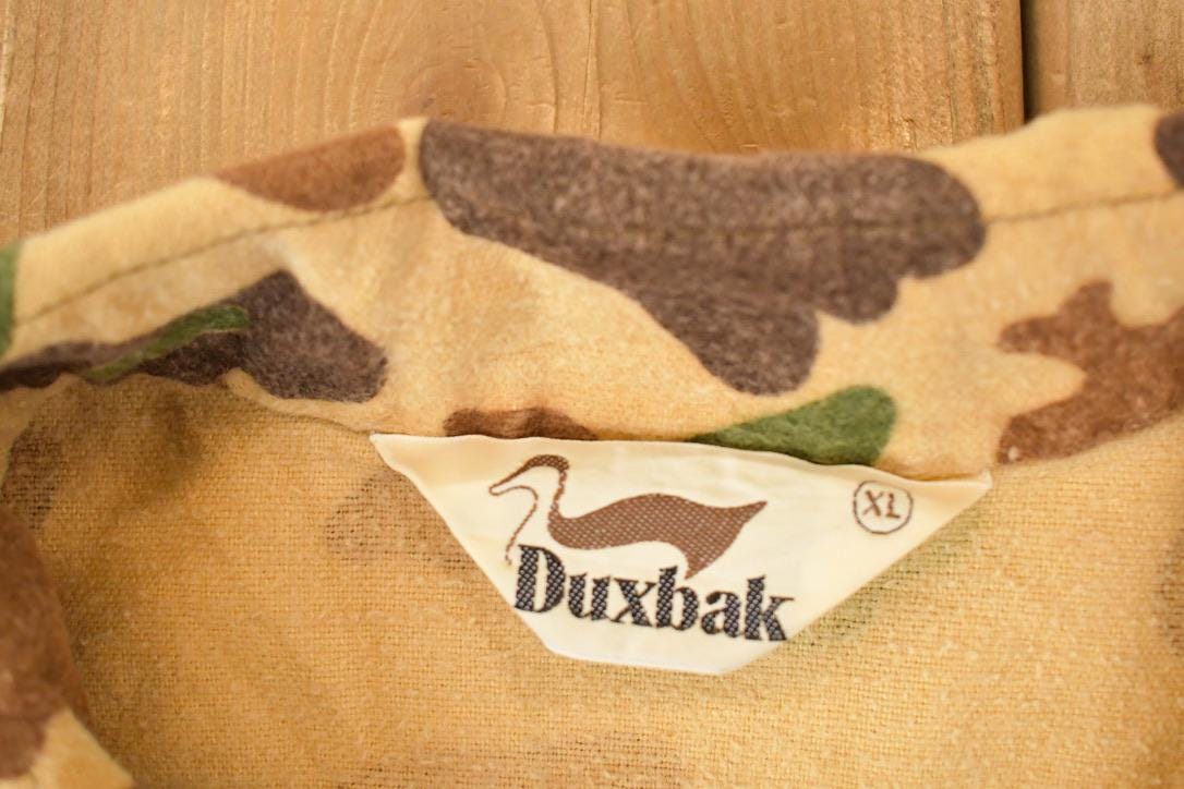 Vintage 1970s Duxbak Camo Button Up Shirt Men's L from propervintagecanada