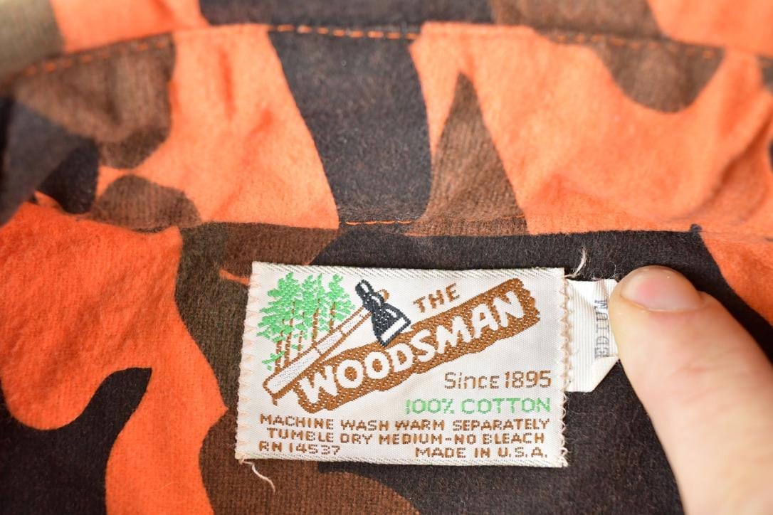 Vintage 1970s The Woodsman Orange Camo Button Up Shirt Mens L from propervintagecanada