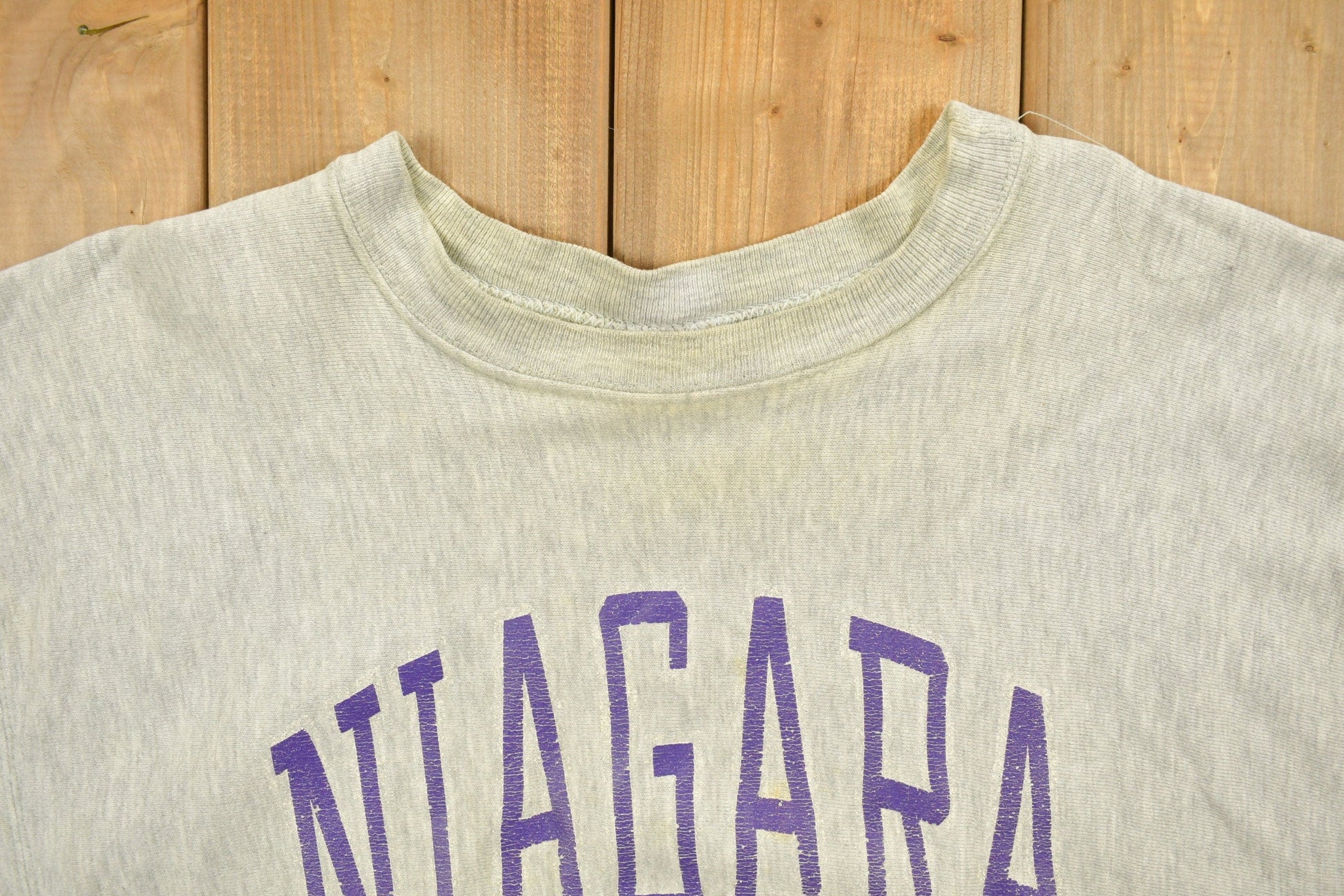Vintage 1980's Champion Reverse Weave Warm-up Collegiate Crewneck University of Niagara Heavily Distressed Men's 2XL from propervintagecanada