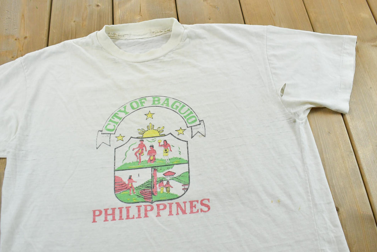 Vintage 1980s City of Baguio Philippines Souvenir Travel T-Shirt Men's L from propervintagecanada