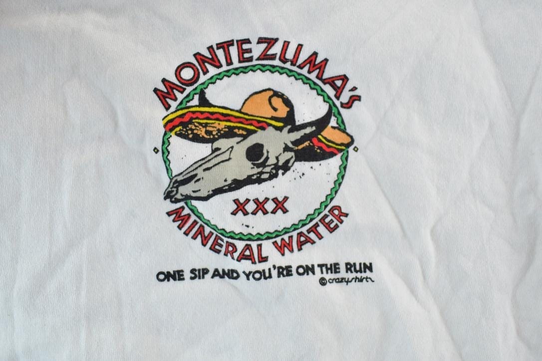 Vintage 1980s Crazy Shirts Montezumas Mineral Water Souvenir Single Stitch Graphic Print T-Shirt Men's Large from propervintagecanada