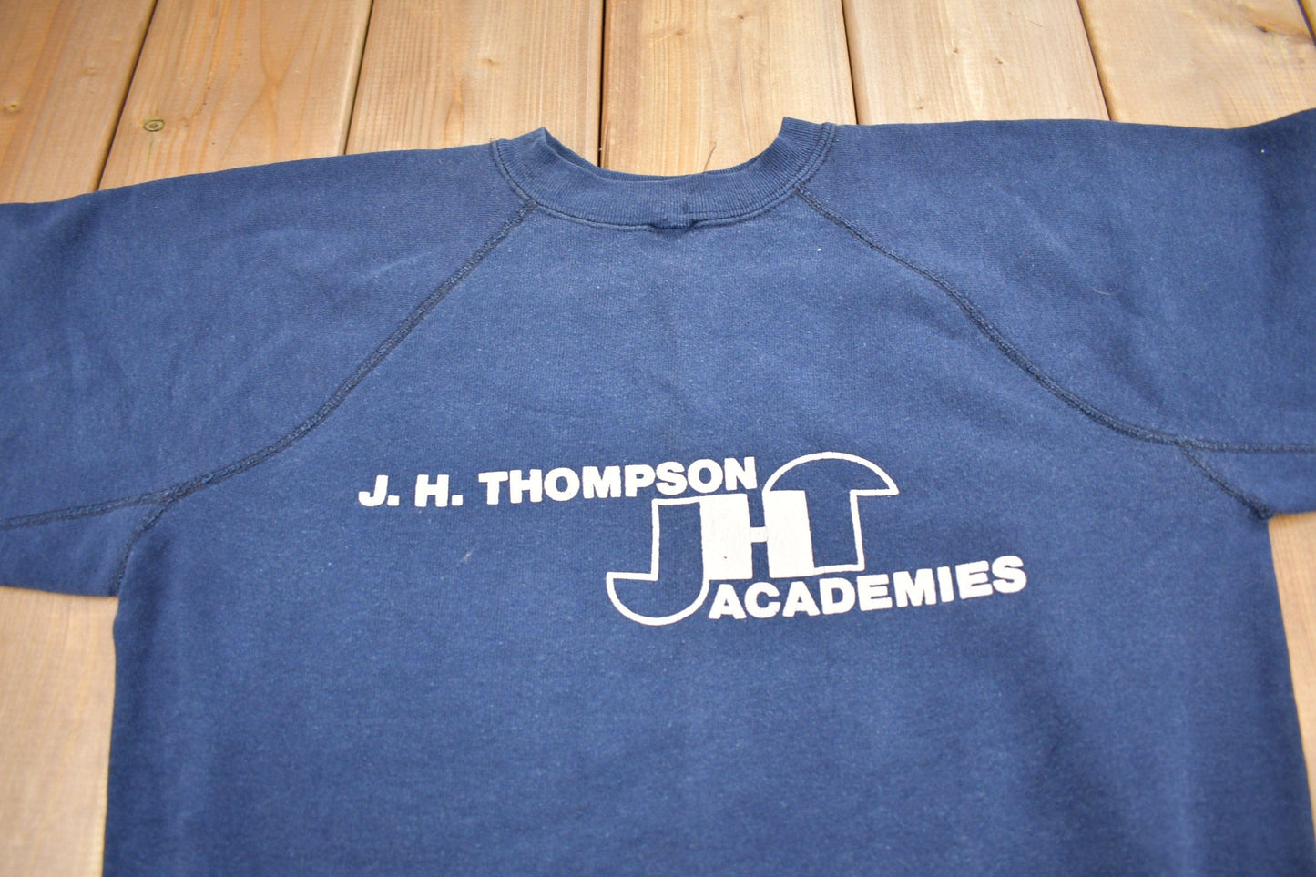 Vintage 1980s J.H. Thompson Academies Graphic Raglan Crewneck Sweatshirt Men's Small from propervintagecanada