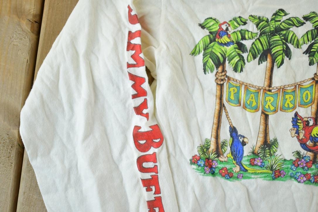 Vintage 1980s Parrothead Jimmy Buffett Souvenir Single Stitch Graphic Print Long Sleeve T-Shirt Men's Small from propervintagecanada