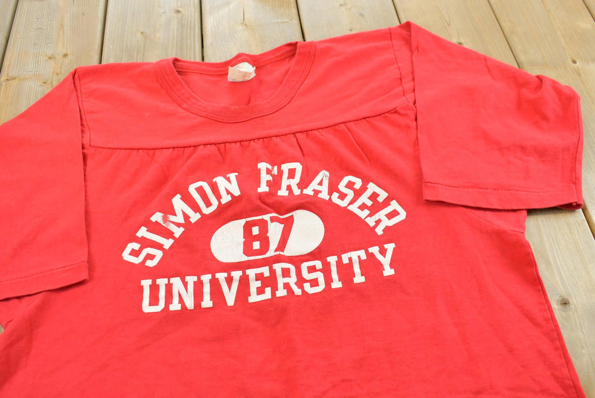 Vintage 1980s Simon Fraser University Three Quarter Sleeve Jersey T-Shirt Men's L from propervintagecanada