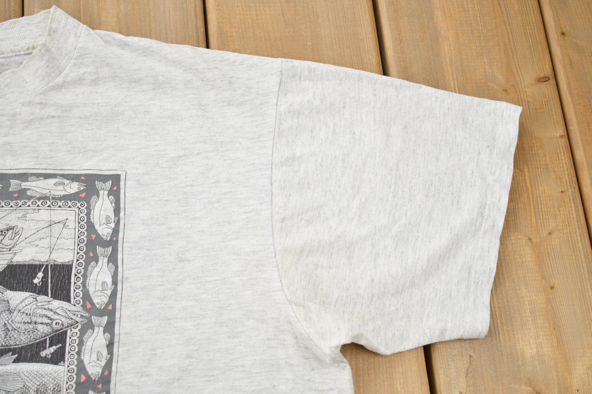 Vintage 1988 Bass Ackwards Fish Ray Troll Graphic T-Shirt Men's Medium from propervintagecanada