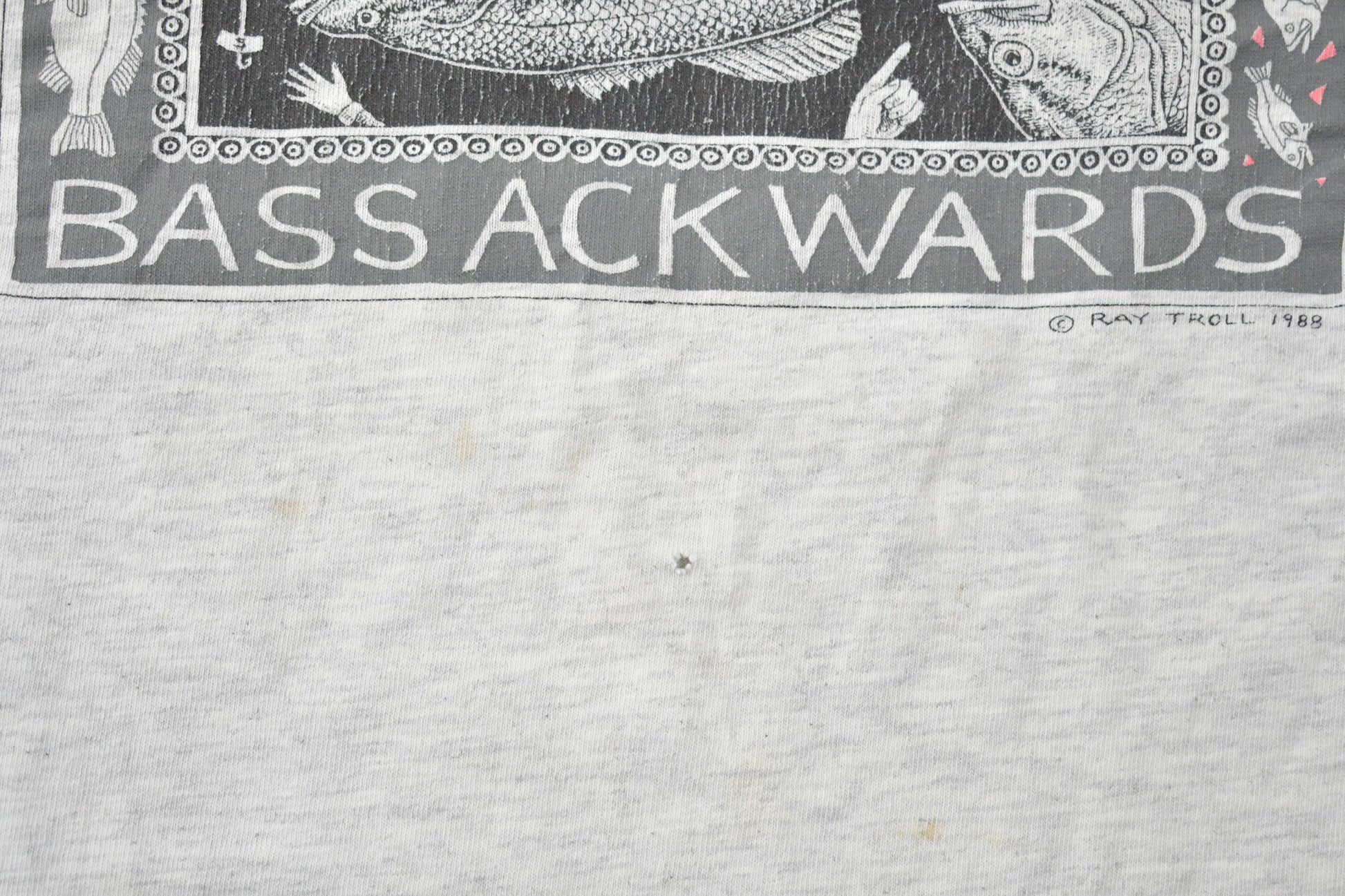 Vintage 1988 Bass Ackwards Fish Ray Troll Graphic T-Shirt Men's Medium from propervintagecanada
