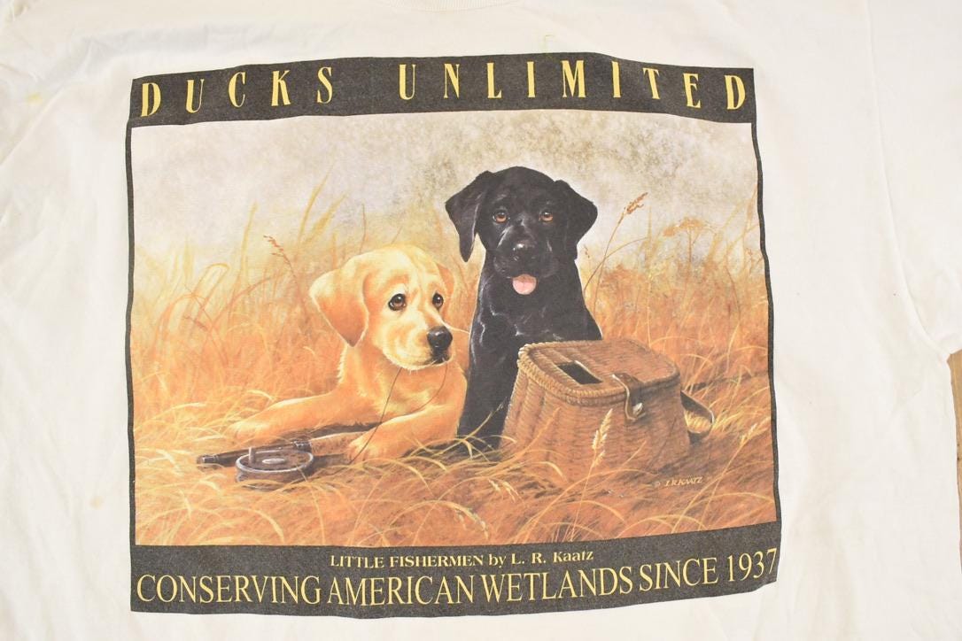 Vintage 1990's Ducks Unlimited Puppy Souvenir Wetlands T-Shirt Men's XL from propervintagecanada