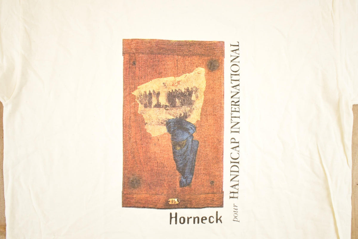 Vintage 1990's Horneck Handicap International Souvenir Travel T-Shirt Men's XL from propervintagecanada