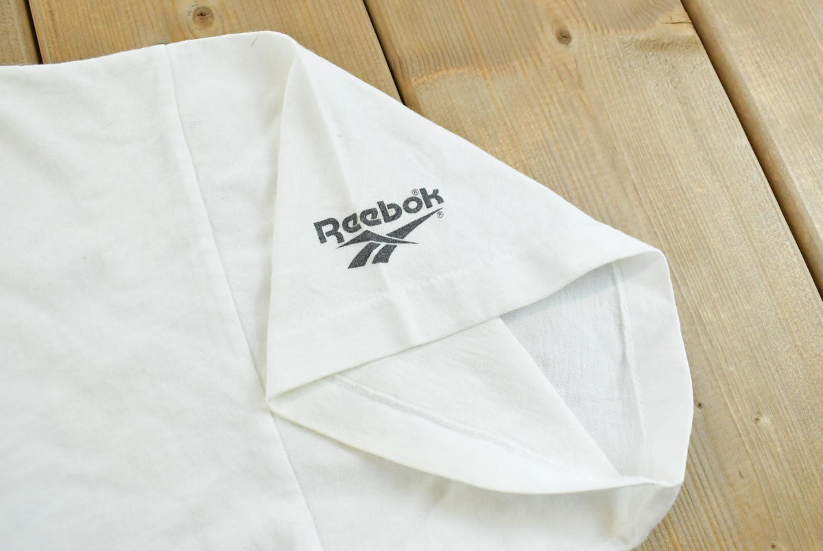 Vintage 1990s Abstract Reebok Promotional T-Shirt Men's Cropped XL from propervintagecanada