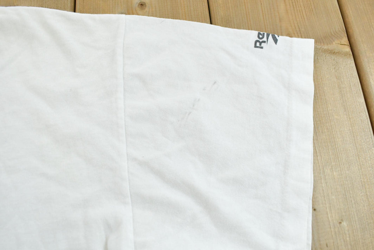 Vintage 1990s Abstract Reebok Promotional T-Shirt Men's Cropped XL from propervintagecanada