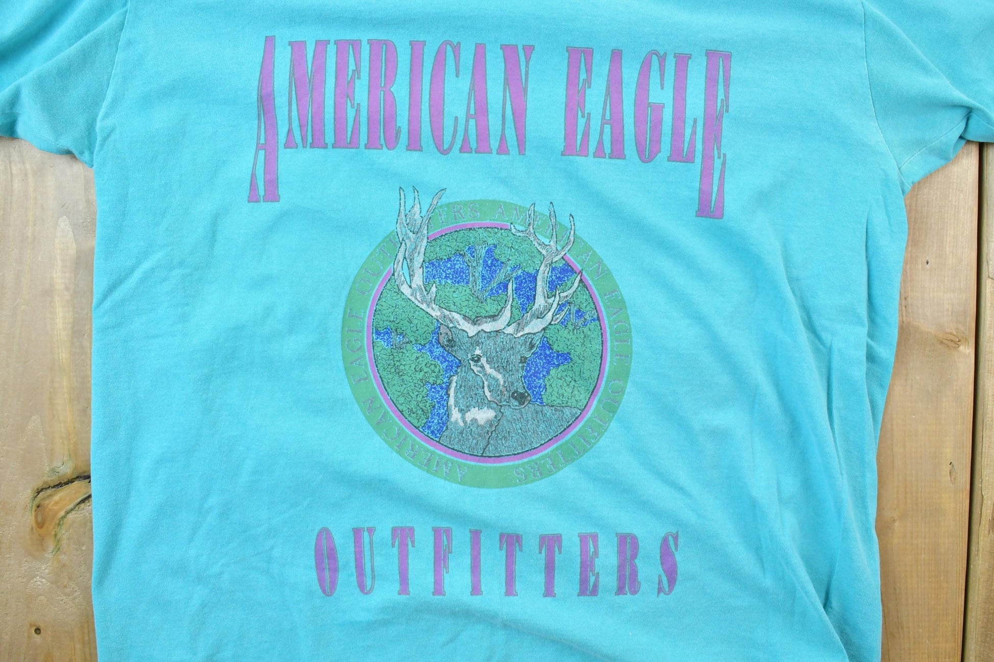 Vintage 1990s American Outfitters Deer Theme Graphic T-Shirt Men's L from propervintagecanada