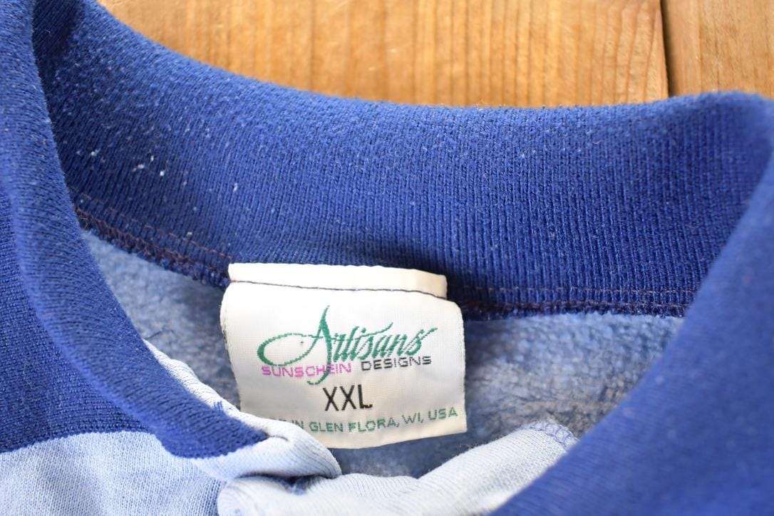 Vintage 1990s Artisans Winter Theme AOP Collared Quarter Button Crewneck Sweatshirt Men's XL from propervintagecanada