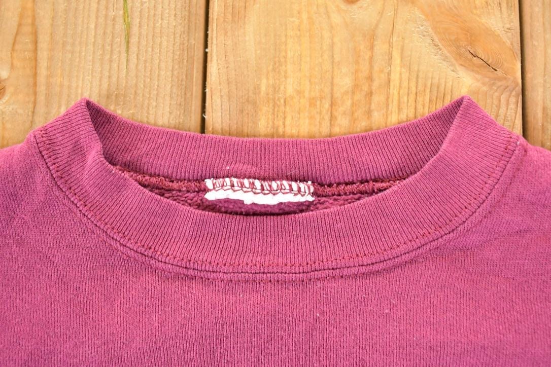 Vintage 1990s Aurora Community College Puppy Patchwork Crewneck Sweatshirt Men's XL from propervintagecanada