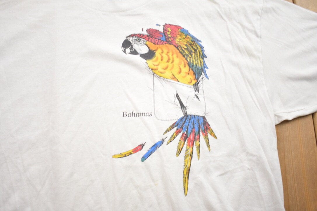 Vintage 1990s Bahamas Parrot Bird Theme Graphic T-Shirt Men's 2XL from propervintagecanada