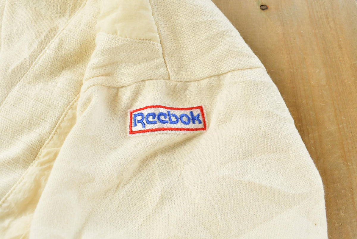 Vintage 1990s Beige Embroidered Reebok Shoulder Mini Logo Crewneck Sweatshirt Men's S from propervintagecanada
