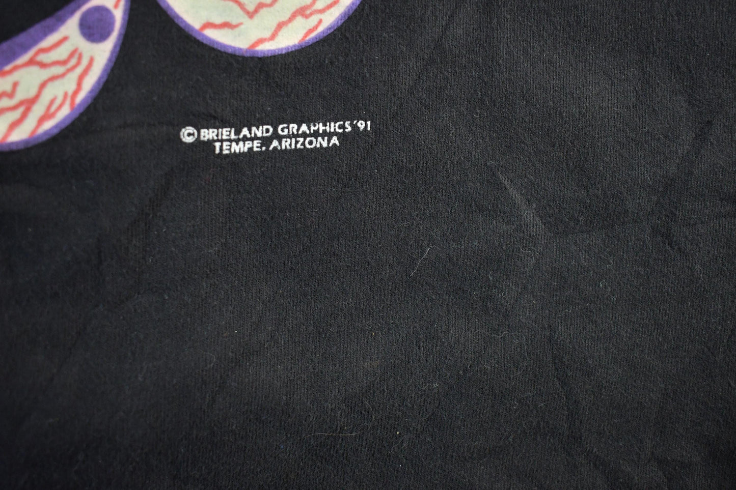 Vintage 1990s Brieland Graphics Glow In The Dark Eyes T-Shirt Men's Large from propervintagecanada