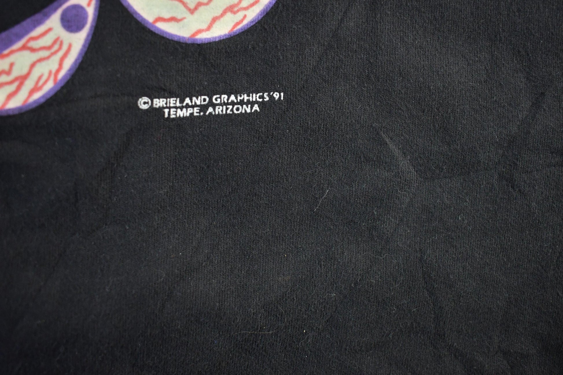 Vintage 1990s Brieland Graphics Glow In The Dark Eyes T-Shirt Men's Large from propervintagecanada