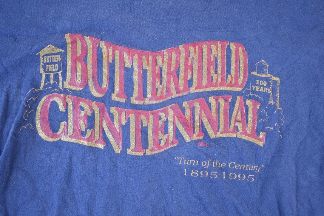 Vintage 1990s Butterfield Centennial Souvenir Single Stitch Graphic Print T-Shirt Men's Large from propervintagecanada