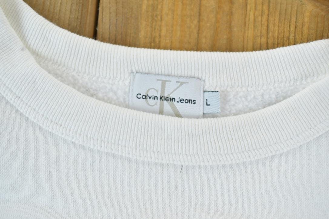 Vintage 1990s Calvin Klein Jeans Crew Neck Sweatshirt Made In USA Men's XL from propervintagecanada