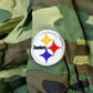 Vintage 1990s Camo Pittsburgh Steelers NFL Football Hooded Puffer Jacket Men's 3XL from propervintagecanada
