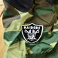Vintage 1990s Camo Raiders NFL Football Hooded Puffer Jacket Men's 3XL from propervintagecanada