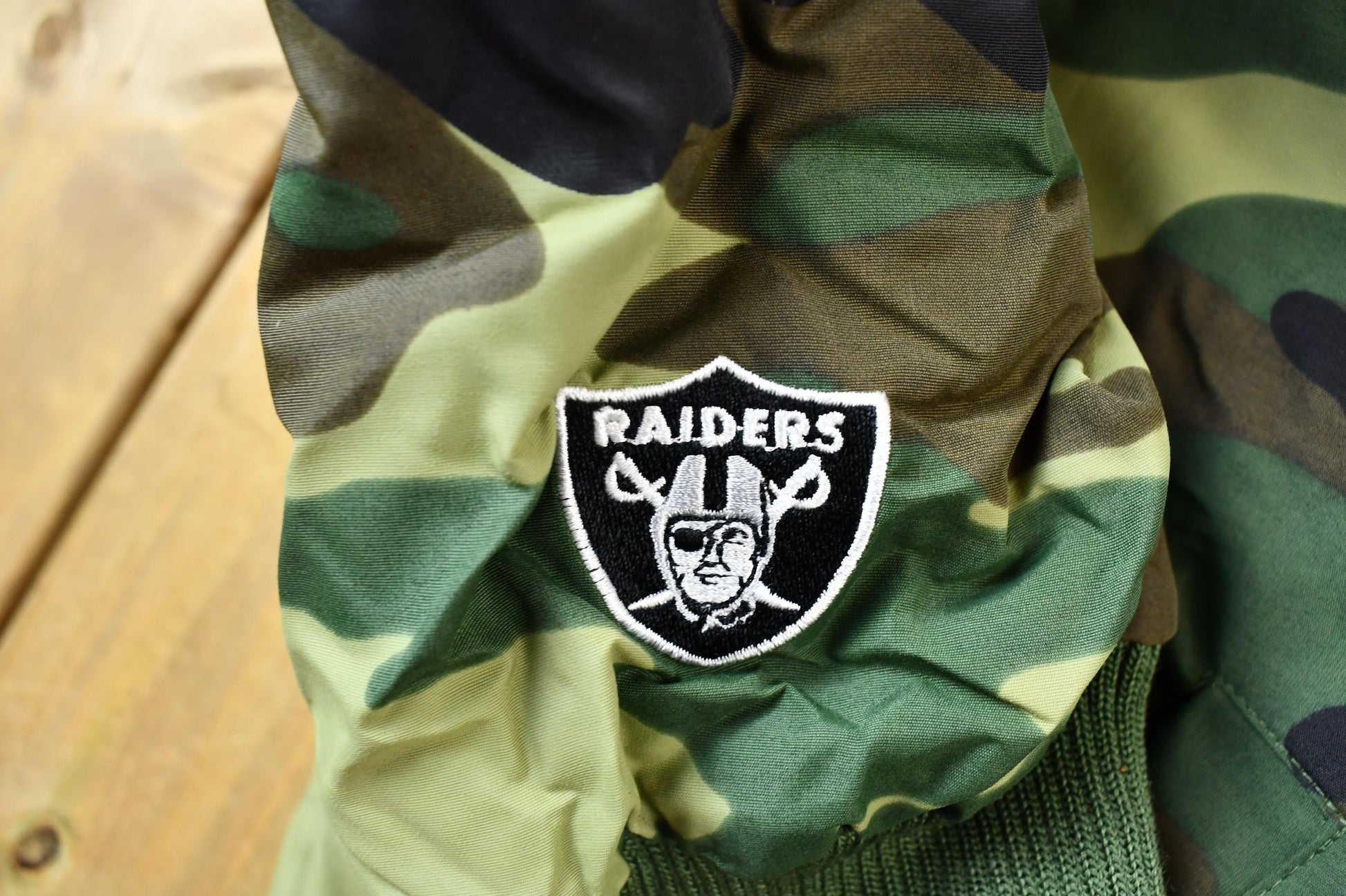 Vintage 1990s Camo Raiders NFL Football Hooded Puffer Jacket Men's 3XL from propervintagecanada