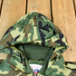 Vintage 1990s Camo Raiders NFL Football Hooded Puffer Jacket Men's 3XL from propervintagecanada