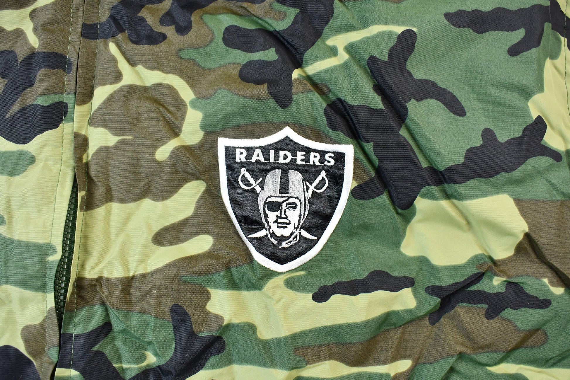 Vintage 1990s Camo Raiders NFL Football Hooded Puffer Jacket Men's 3XL from propervintagecanada