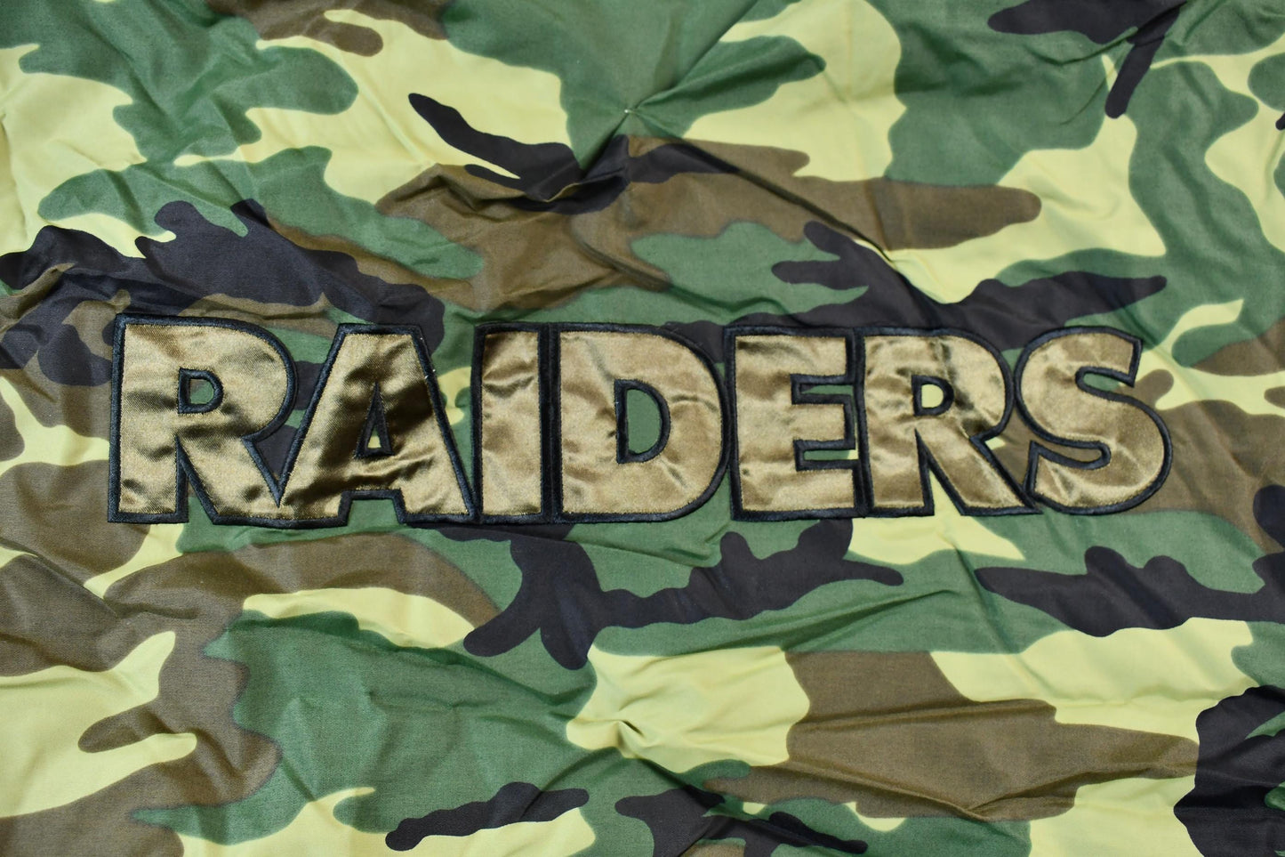 Vintage 1990s Camo Raiders NFL Football Hooded Puffer Jacket Men's 3XL from propervintagecanada