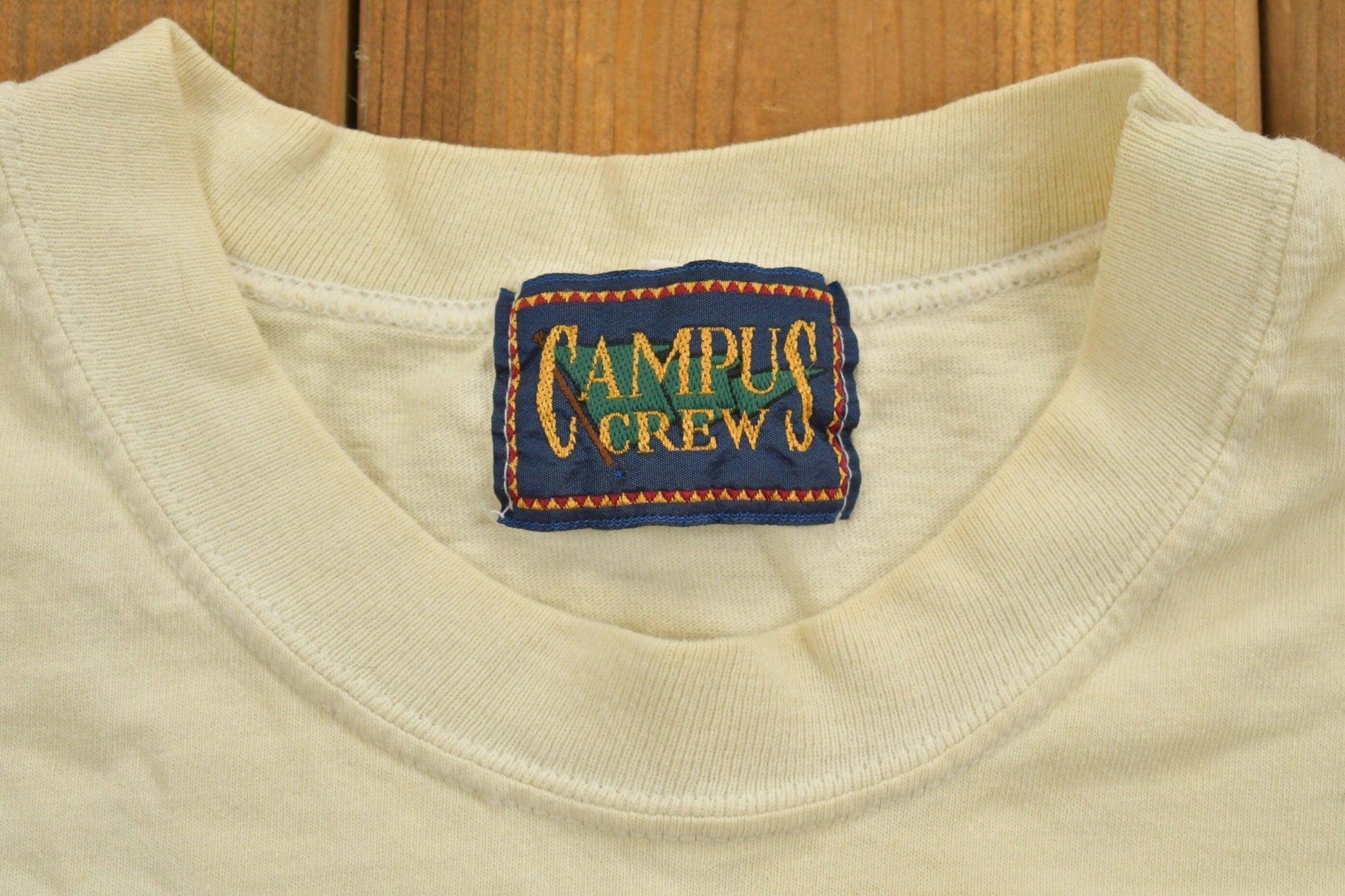 Vintage 1990s Campus Crew Wear University Collegiate T-Shirt Men's XL from propervintagecanada