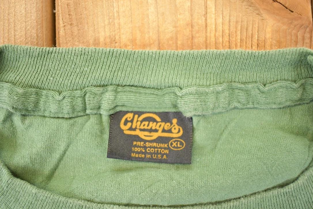 Vintage 1990s Canadian Rugged Daffy Duck Looney Tunes Fishing Souvenir T-Shirt Men's XL from propervintagecanada
