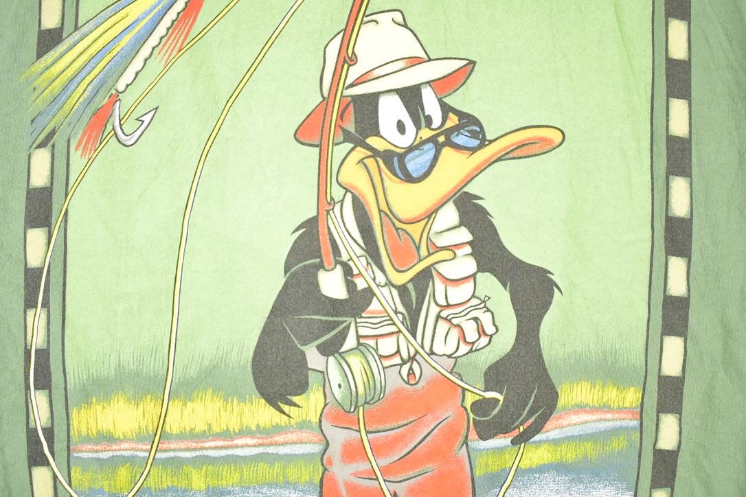 Vintage 1990s Canadian Rugged Daffy Duck Looney Tunes Fishing Souvenir T-Shirt Men's XL from propervintagecanada