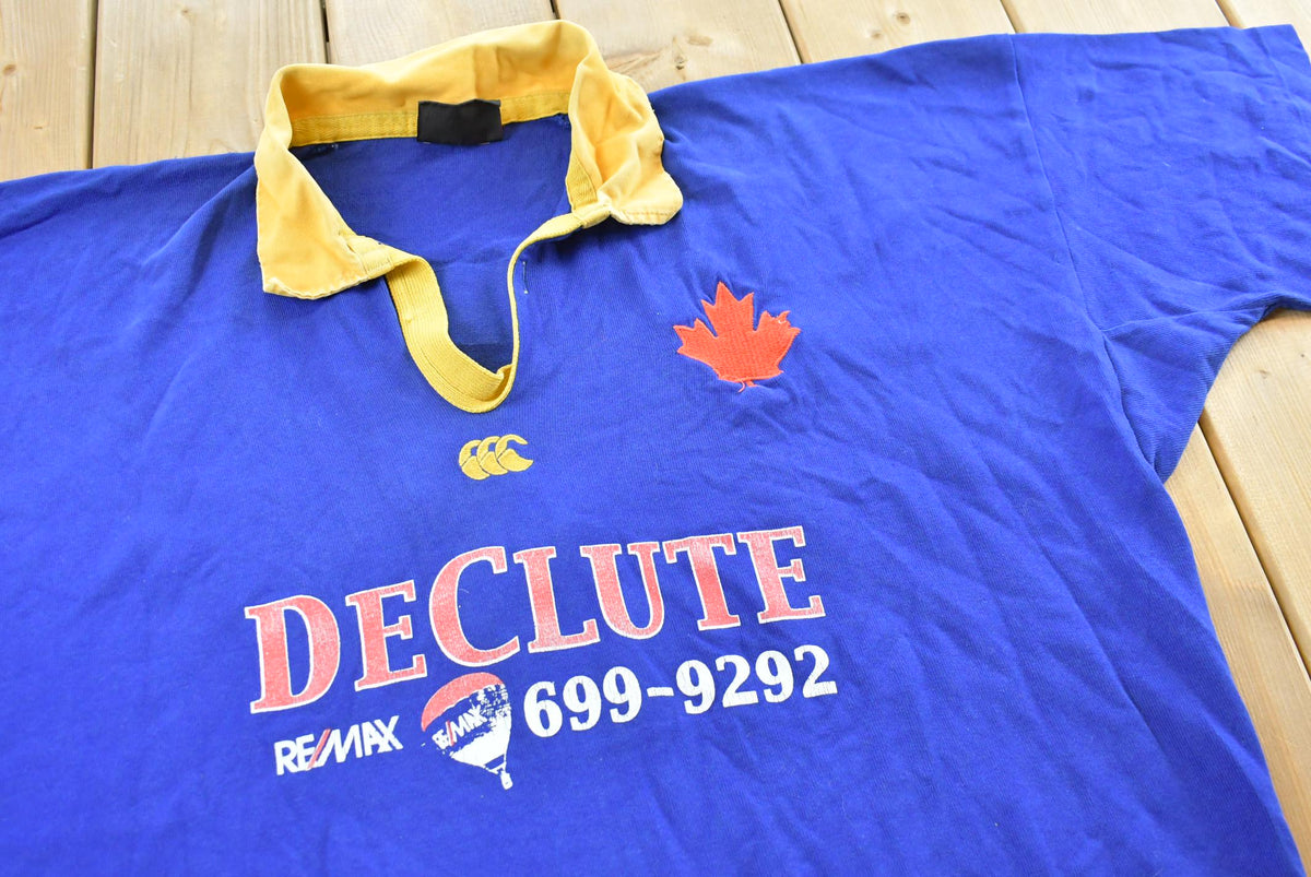 Vintage 1990s Canterbury DeClute Remax Rugby Jersey Polo Collared T-Shirt Mens 2XL from propervintagecanada