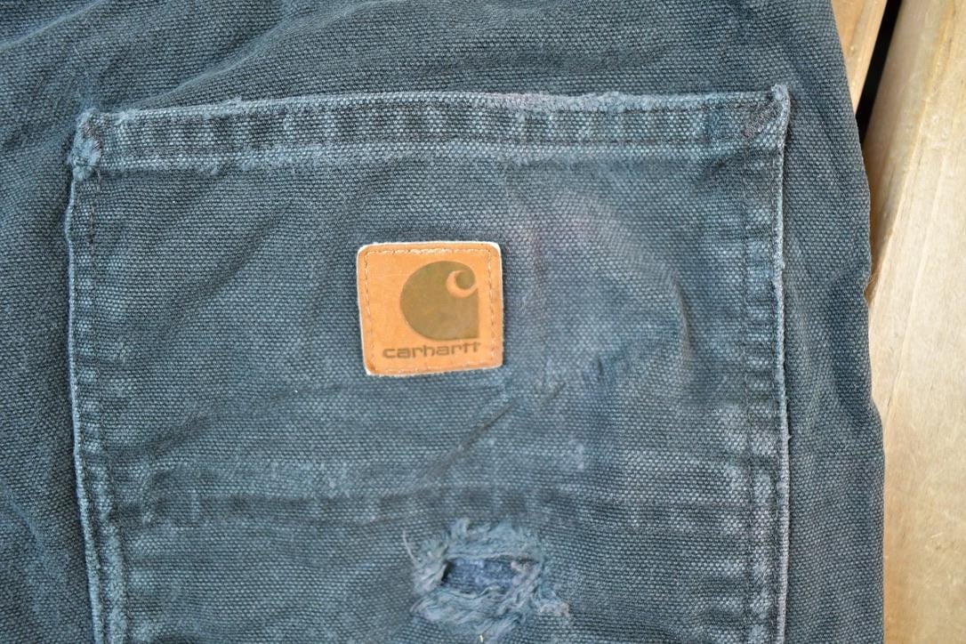 Vintage 1990s Carhartt Black Denim Work Jeans Men's 38 x 32 from propervintagecanada